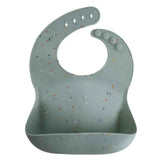Mushie® Bavaglino in silicone Cambridge Blue Confetti