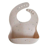 Mushie®  Bavaglino in silicone Vanilla Confetti