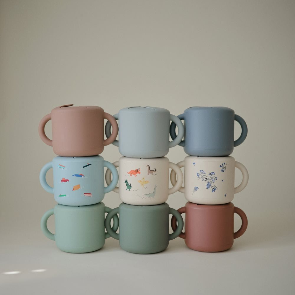 Mushie® Silikonska posodica za prigrizke Dinosaurs Mushie